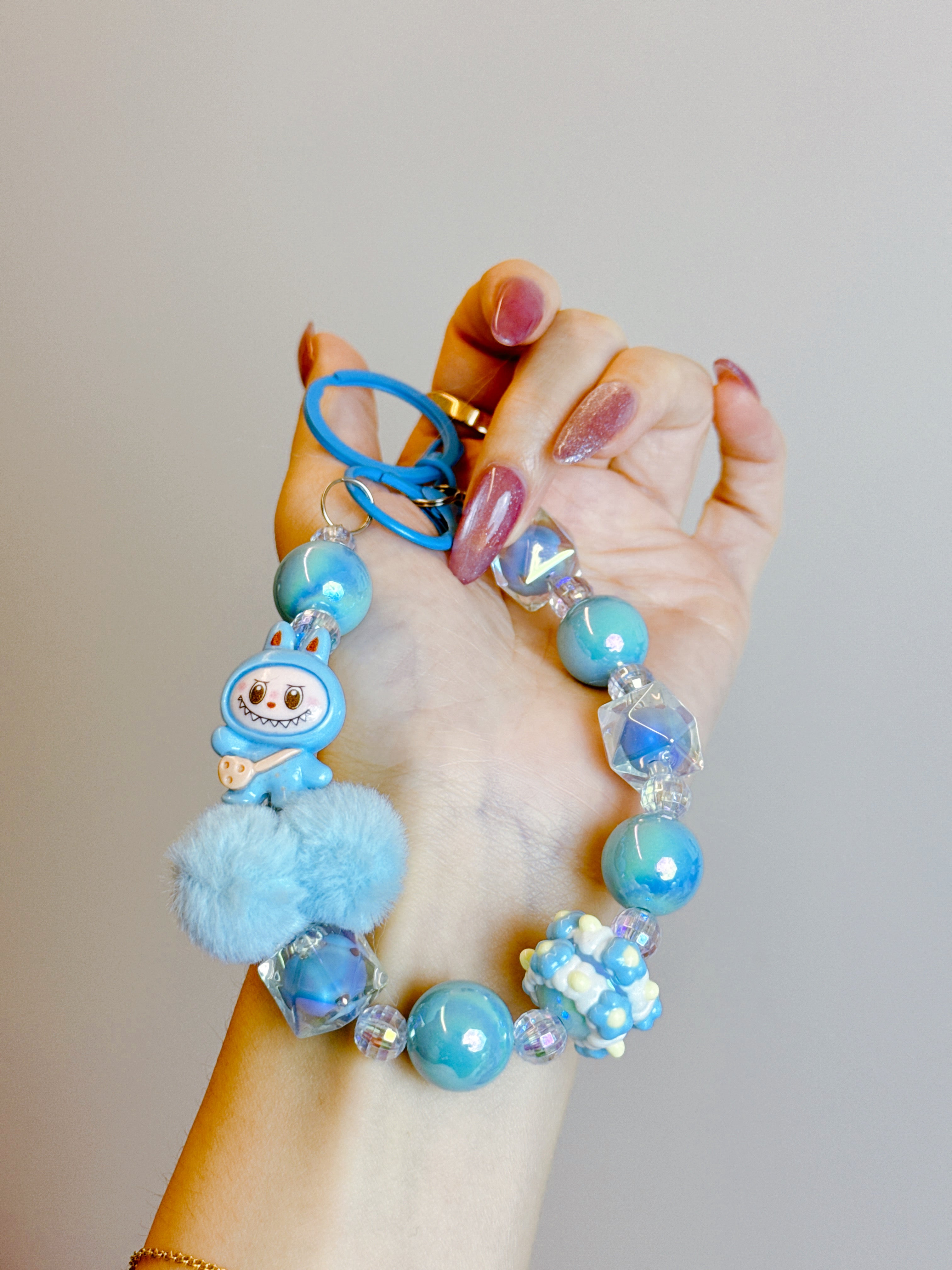 Labubu Phone Chain – Beaded Wrist Strap with Fluffy Pom-Pom & Resin Mini-Doll Charm